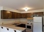 Unit B's kitchen has ample cabinet and counter space, an electric range, dishwasher and refrigerator.