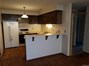 Unit A's kitchen has ample cabinet and counter space, an electric range, dishwasher and refrigerator.