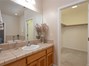 One of the vanities in the master bath with view into large walk-in closet, more storage!